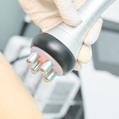 Perfect body radio treatment. Woman at spa procedure. Doctor hand and girl body. RF cosmetology lifting.